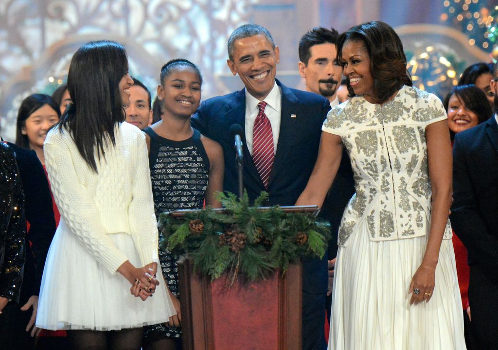 Malia Obama, Sasha Obama, US President Barack Obama, and First Lady Michelle Obama onstage at TNT Christmas in Washington 2013 at the National Building Museum on December 15, 2013 in Washington, DC