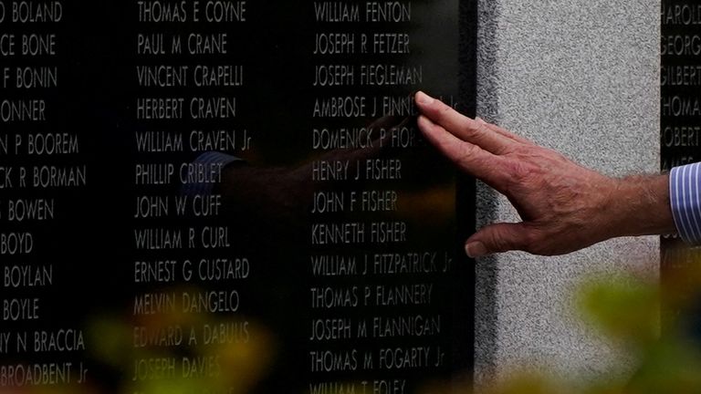 US President Joe Biden touches the name of his uncle, Ambrose J. Finnegan Jr., who died in World War II, while visiting a war memorial in Scranton, Pennsylvania, US, on April 17, 2024. REUTERS/Elizabeth Frantz
