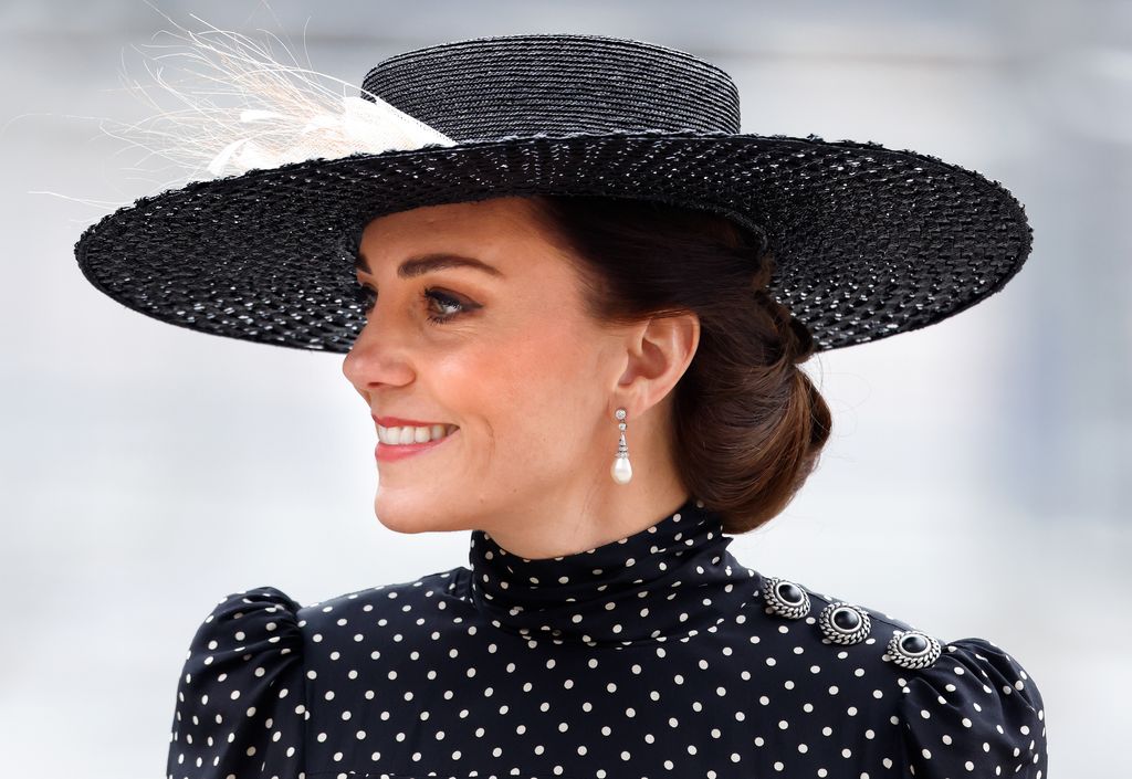 Princess Kate wearing black and white polka dots and a hat